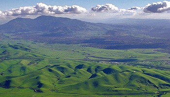 A scenic aerial view of rolling green hills near Concord with Mount Diablo visible in the background.