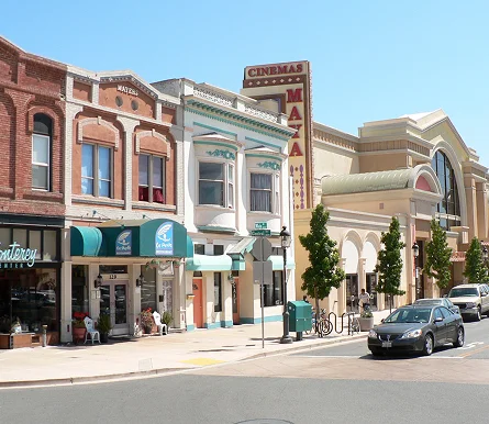 a street corner with shops and stores on the side